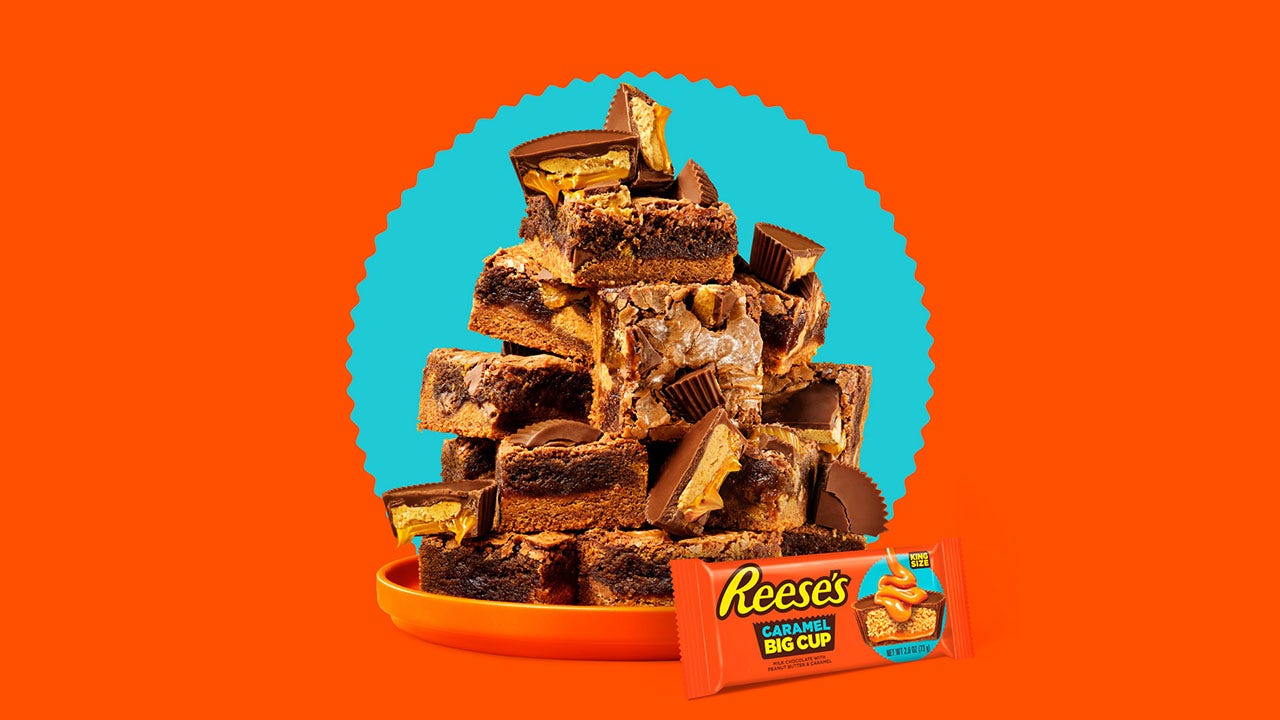 orange plate piled high with reeses caramel cup brownies