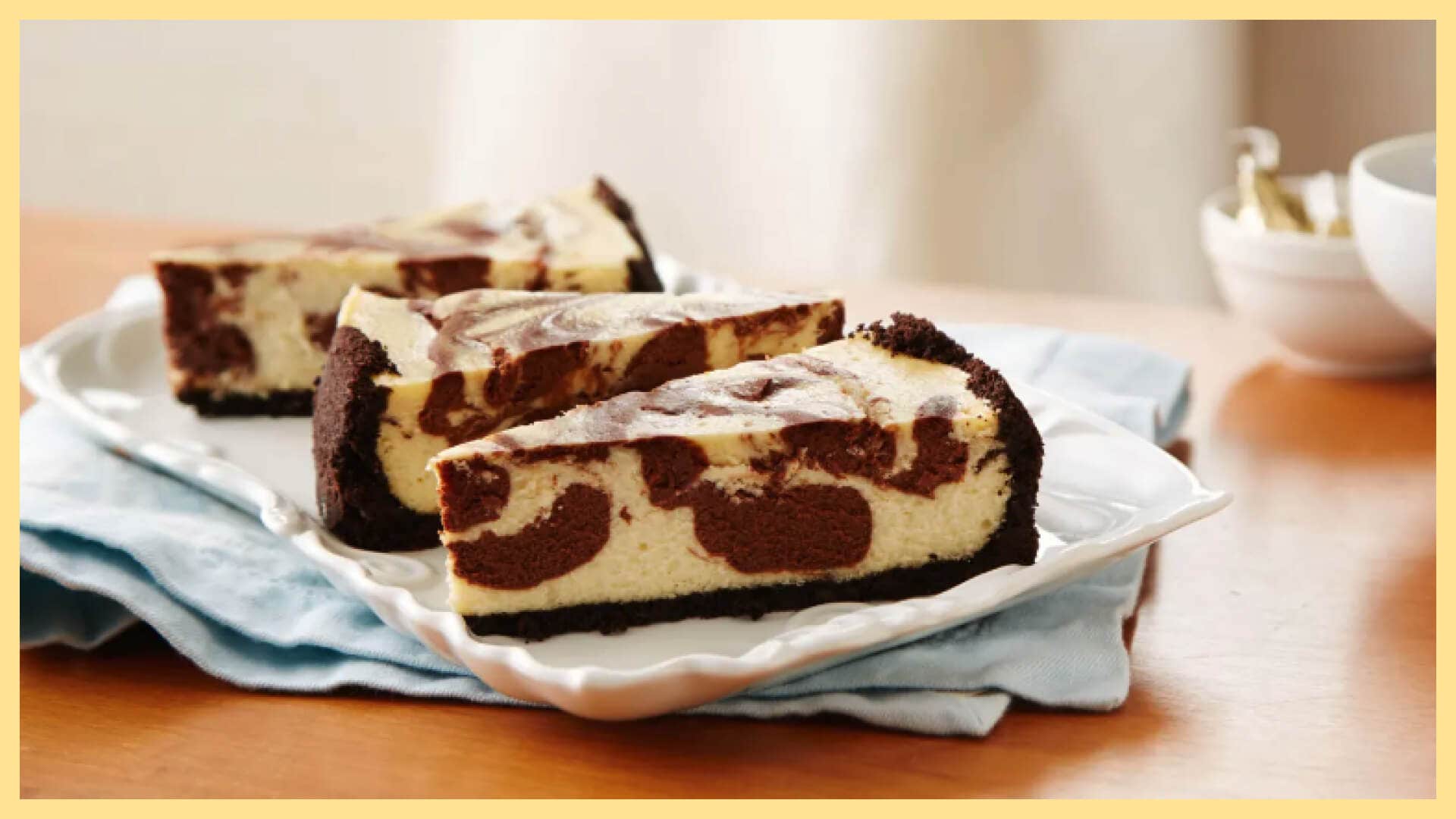 serving plate with three slices of chocolate swirl cheesecake with chocolate crust