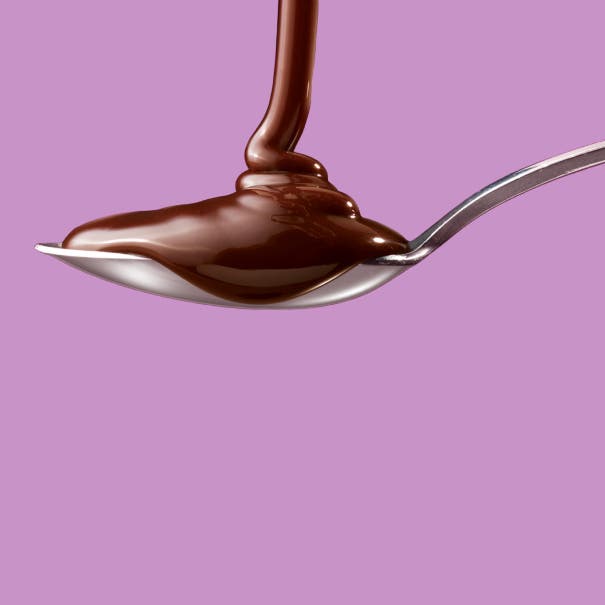 hersheys chocolate syrup being poured into a spoon