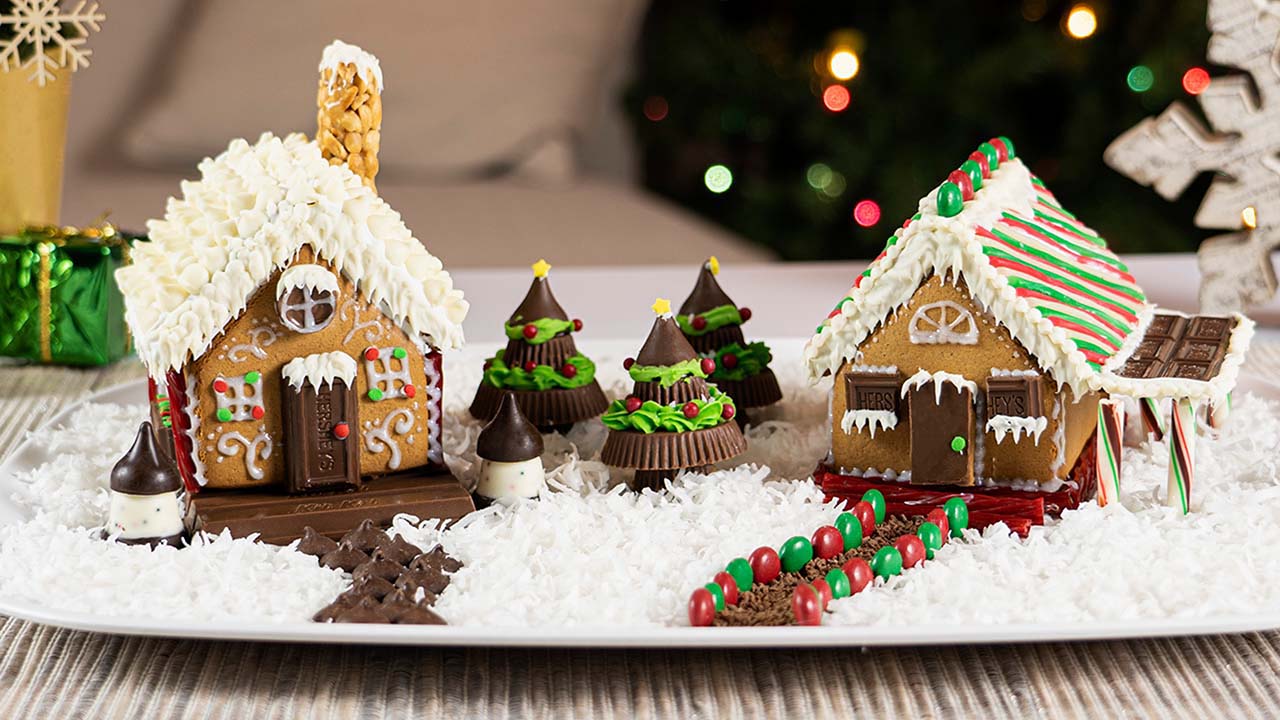 fully decorated gingerbread houses made with hersheys candy and white icing