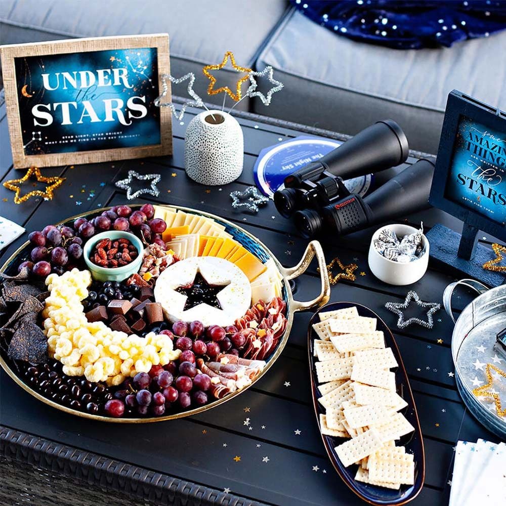 table full of stargazing food trays and party decorations